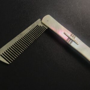 Silver dog comb with iridescent mother-of-pearl handle by John & Joseph Storr