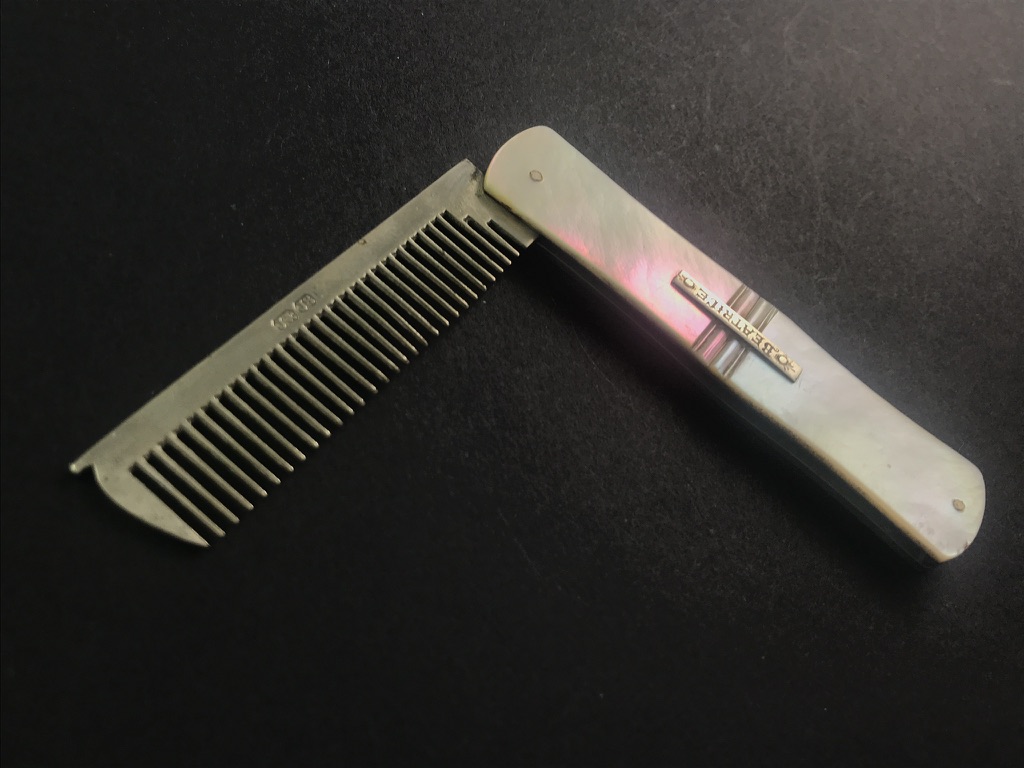 Silver dog comb with iridescent mother-of-pearl handle by John & Joseph Storr